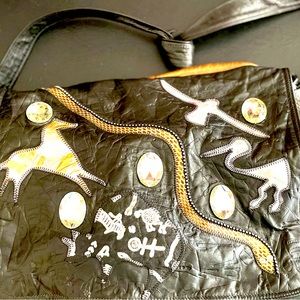 Quality designer leather shoulder bag. Featuring Native American Petroglyphs.